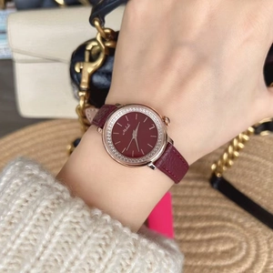 Detail of Mishali women's watch featuring a red dial and rose gold diamond-set bezel