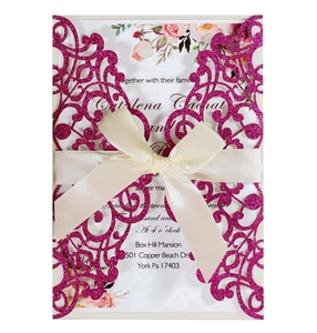 Laser-cut fuchsia glitter wedding invitation with cream ribbon detail and elegant cutout