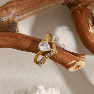 Macro shot of 18K gold plated double layer crown ring with pear shaped zircon on wood