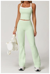 Detail view of high waist mint green flare pants with contrast trim and slim fit design