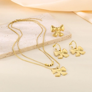 Detailed set of 18K gold-plated bow jewelry with layered necklace, earrings, and ring