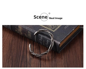 Close-up of vintage Thai silver twisted wire cuff bracelet on a leather book