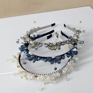 Detail showing three handcrafted crystal headbands with pearls and rhinestone clusters
