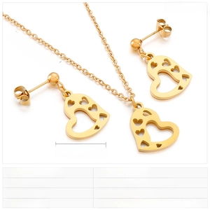 Detailed view of golden heart-shaped necklace and earring set with size specifications