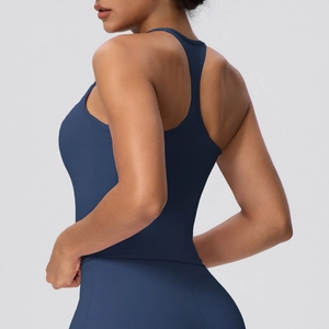 Detail of dark blue racerback yoga tank top showing seamless fit and athletic fabric