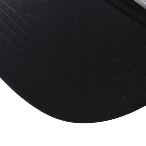 Close-up of black cotton baseball cap brim with four parallel rows of reinforced stitching