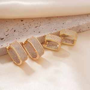 Elegant gold rectangle hoop earrings with pave cubic zirconia on beige stone and satin
