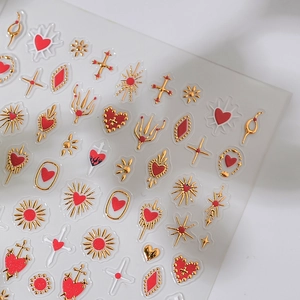 Metallic gold and red sacred heart nail art stickers with cross and star patterns