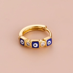 Detail of bohemian gold hoop earring with blue square evil eye and clear zircon stones