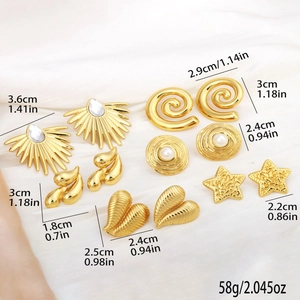 Set of six vintage gold earrings featuring heart, star, and spiral designs on white satin