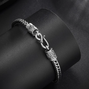 Macro detail of a 4mm vintage silver snake bone chain with a retro S-hook clasp