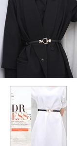 Detail of slim black leather belt with gold round hook buckle for dresses and suits