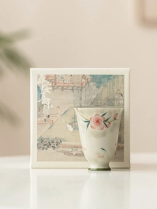 Detailed view of hand-painted peach blossom ceramic teacup with elegant premium gift box