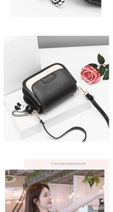 Detail of a chic black and white flap bag with metal logo and astronaut keychain charm