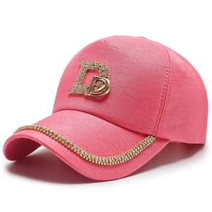Pink baseball cap with rhinestone letter D and sparkling gold crystal chain on the brim