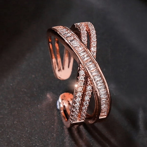 Macro shot of rose gold cross geometric ring featuring sparkling pavé zircon stones