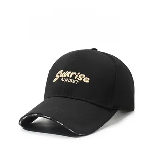 Close-up of golden embroidery and SPORT text detail on black baseball cap brim