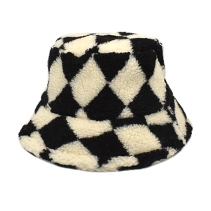 Close-up of black and white checkerboard plush bucket hat with thick faux fur texture