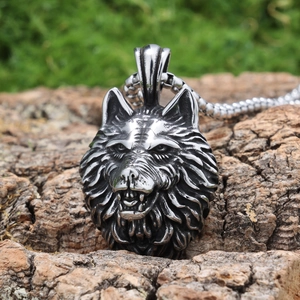 Gothic wolf head pendant necklace in stainless steel on natural moss wood background