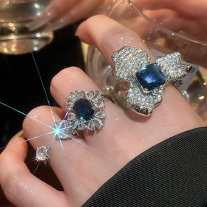 Détail d'un ensemble de bagues fleurs de luxe avec saphirs bleus et zircons brillants