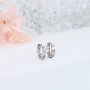 Close-up of S925 sterling silver hoop earrings with Greek key pattern on white background