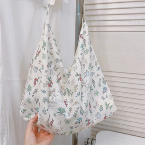 Detail of a large cotton hobo bag featuring colorful botanical and snail prints