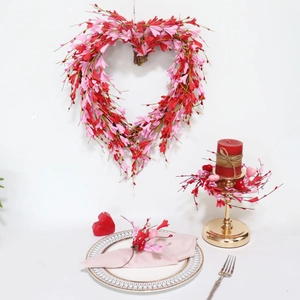 Close-up of heart-shaped floral napkin ring and matching candle wreath set