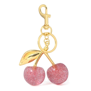 Detailed macro view of pink glitter resin cherries with gold leaf and metal lobster clasp