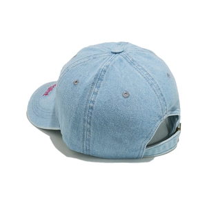 Detail of light blue washed denim baseball cap with red embroidery and metal strap buckle