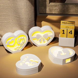 Close-up of heart-shaped Mama night light with warm LED glow and hollow silhouette