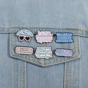 Inspirational enamel pins set on denim jacket with colorful motivational metal badges