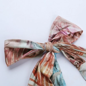 Macro detail of tropical print fabric with bow knot on summer beach dress