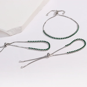 Adjustable silver chain bracelets with green round-cut zircons set in a three-piece set