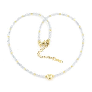 Detailed view of blue crystal beaded necklace featuring a polished gold heart pendant