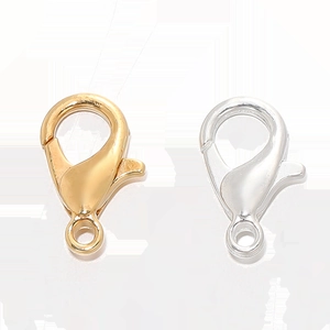 Close-up of gold and silver lobster clasps jewelry making components set