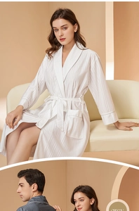 Detail of the soft vertical striped texture on cotton blend bathrobe with a shawl collar