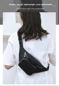 Rear view of a black water-resistant waist bag worn across the back with adjustable strap