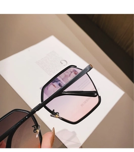 Close-up of pink purple gradient lenses on stylish square metal frame sunglasses
