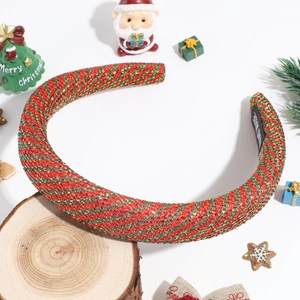 Close-up of handmade red and green sparkly striped Christmas headband with gold tinsel