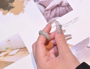 Detailed close-up of a 925 sterling silver ring with five rows of micro-pave crystals