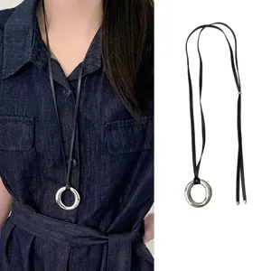 Minimalist silver ring pendant necklace with black woven rope and textured finish