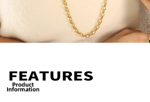 Detail view of 18k gold plated OT toggle chain necklace on a beige knitted sweater