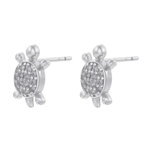 Macro shot of silver turtle stud earrings with sparkling crystals on a white background