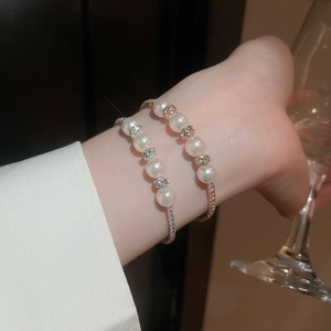 Close-up of double-layer pearl bracelet with rhinestone spacers on a model's wrist