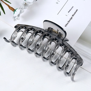 Detail of a large translucent grey hair claw clip showing durable teeth and spring