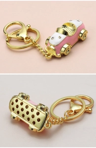 Detailed view of pink and white car keychain with gold metal plating and crystal accents