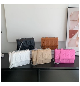 Detailed display of five colors of quilted crossbody chain bags in a modern setup