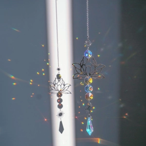 Lotus suncatcher with metal frame and crystal beads casting rainbow light on the wall
