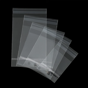 Macro shot of multiple sizes of transparent OPP self-sealing bags on a black background