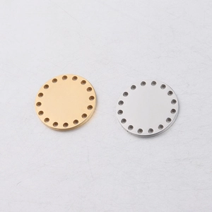 Close-up of gold and silver stainless steel round pendant charms with pre-drilled holes